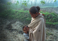 Rina Dewri, fairly paid artisan at Prokritee in Bangladesh, with daughter Antara starting school